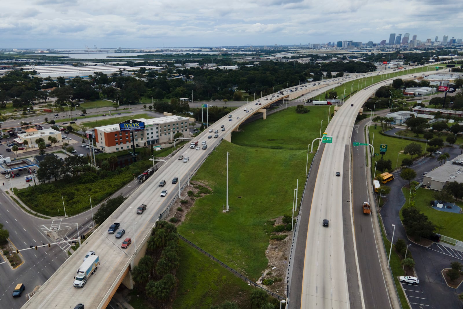 In this image taken with a drone, the Tampa, Fla., skyline, top right, is seen at a distance as traffic flows eastbound, left lanes, along Interstate 4 as residents continue to follow evacuation orders ahead of Hurricane Milton, Tuesday, Oct. 8, 2024. (AP Photo/Julio Cortez)