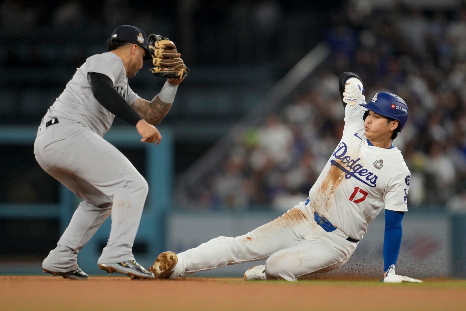 Los Angeles Dodgers' Shohei Ohtani is tagged out by New York Yankees second baseman Gleyber Torres on a steal attempt during the seventh inning in Game 2 of the baseball World Series, Saturday, Oct. 26, 2024, in Los Angeles. Ohtani was injured on the play and helped off the field. (AP Photo/Ashley Landis)