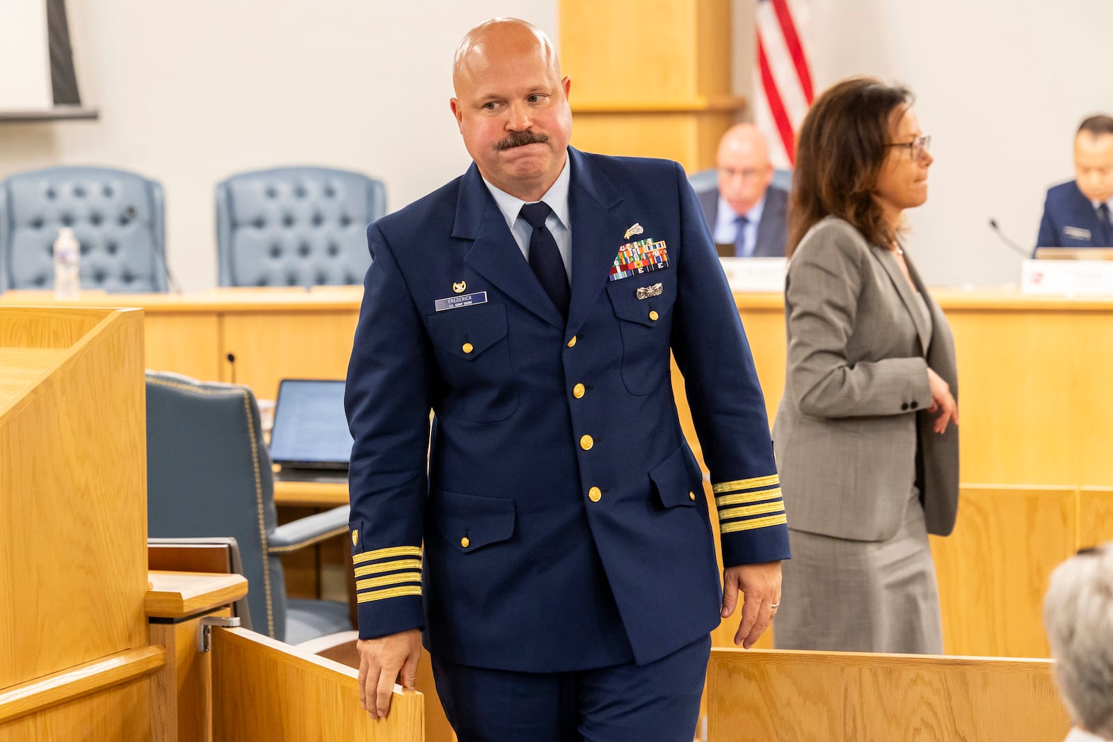 Captain Jamie Frederick, with the U.S. Coast Guard Sector Boston, leaves the hearing while in a break during the final day of the Coast Guard investigatory hearing on the causes of the implosion of an experimental submersible headed for the wreck of the Titanic, Friday, Sept. 27, 2024, in North Charleston, S.C. (AP Photo/Mic Smith)