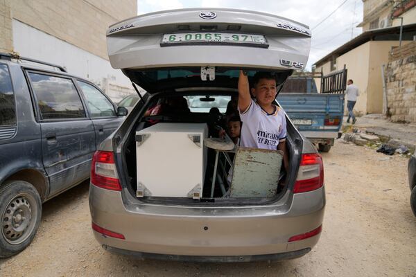 Residents of the now evacuated refugee camp of Tulkarem return to collect belongings before the destruction of their homes as Israeli forces prepare to carry out the demolition of 116 homes across the two refugee camps of the Israeli occupied West Bank city of Tulkarem, Friday, May 2, 2025. (AP Photo/Nasser Nasser)