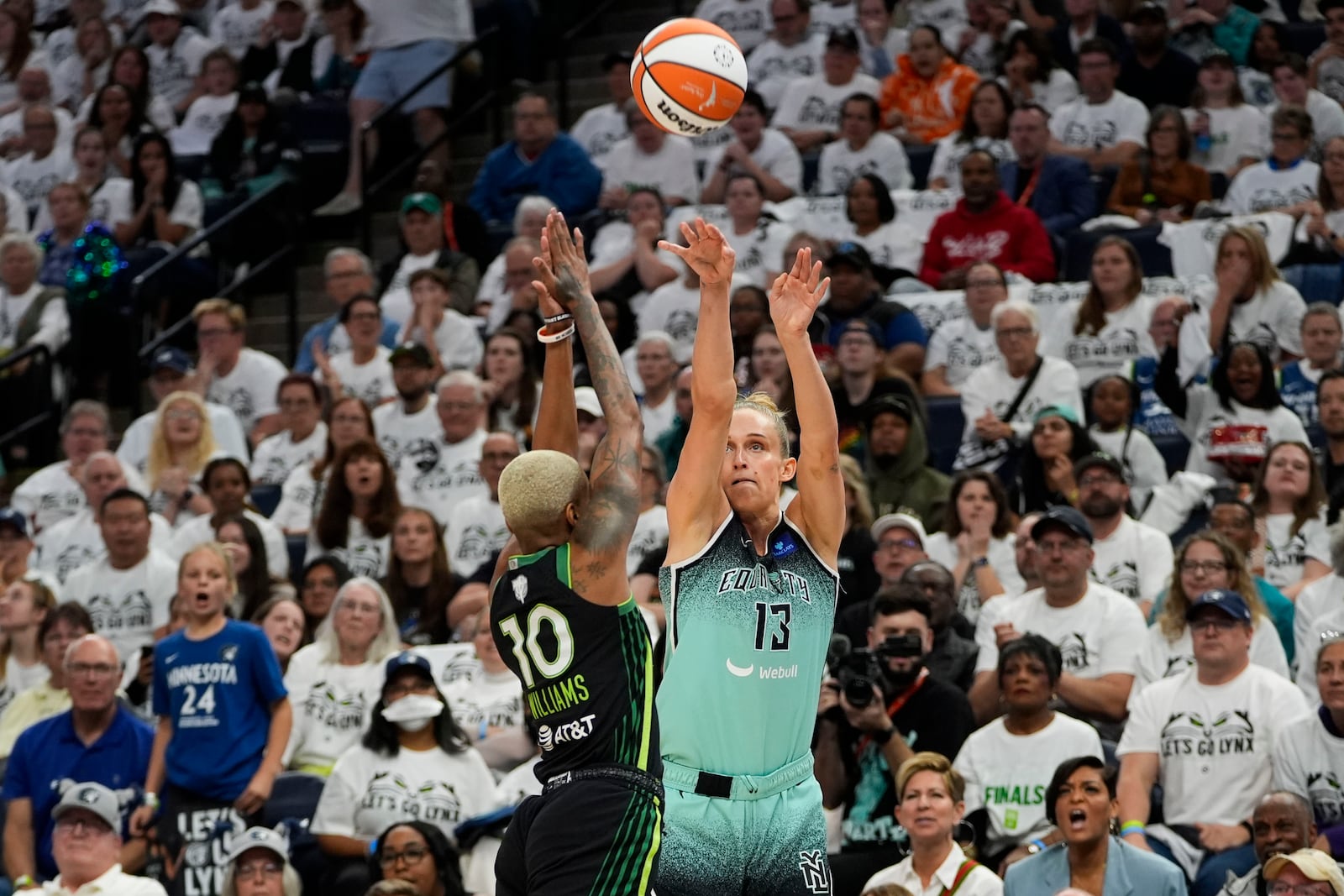 New York Liberty forward Leonie Fiebich (13) shoots against Minnesota Lynx guard Courtney Williams (10) during the first half of Game 4 of a WNBA basketball final playoff series, Friday, Oct. 18, 2024, in Minneapolis. (AP Photo/Abbie Parr)