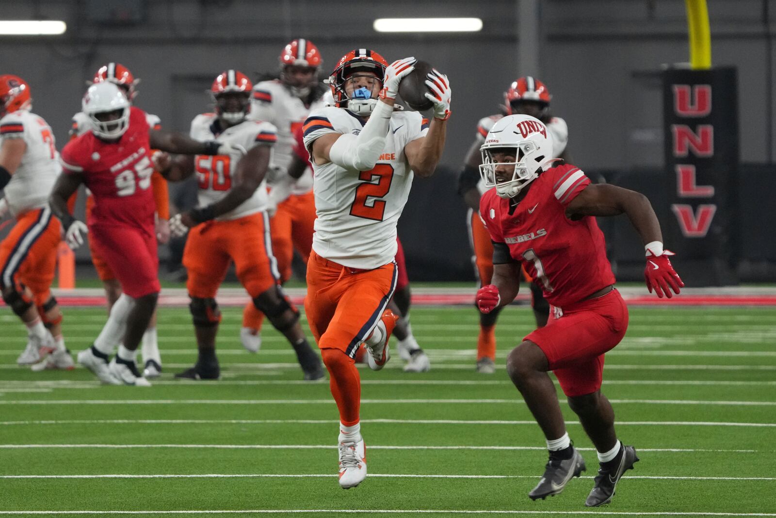 Syracuse wide receiver Trebor Pena (2) makes the catch over UNLV defensive back Jalen Catalon (1) in the first half during an NCAA college football game, Friday, Oct. 4, 2024, in Las Vegas. (AP Photo/Rick Scuteri)