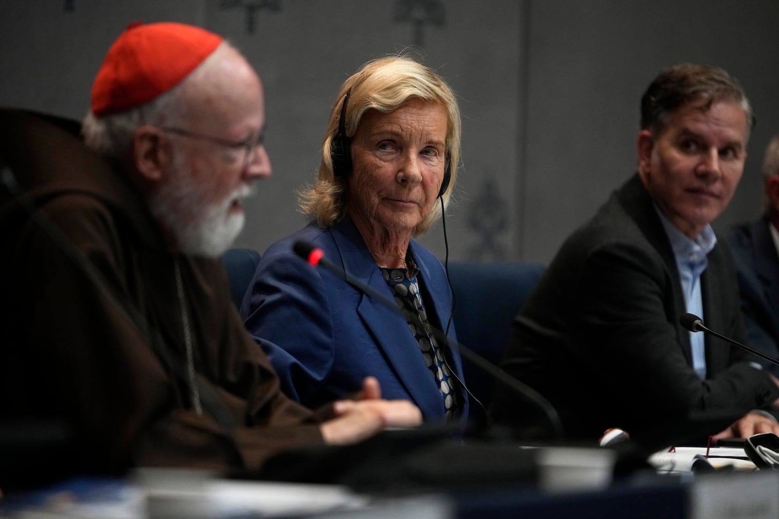 Clergy sex abuse survivor and victim's advocate Juan Carlos Cruz, right, listens to Cardinal Sean Patrick O' Malley speaking during a press conference to present the Vatican's first Annual Global Report on Minors Protection at the Vatican press center, Tuesday, Oct. 29, 2024. (AP Photo/Alessandra Tarantino)