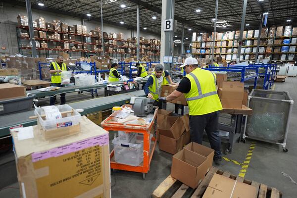 FILE - Employees of Learning Resources, an educational toy company, work at a warehouse in Vernon Hills, Ill., Friday, April 11, 2025. (AP Photo/Nam Y. Huh, File)