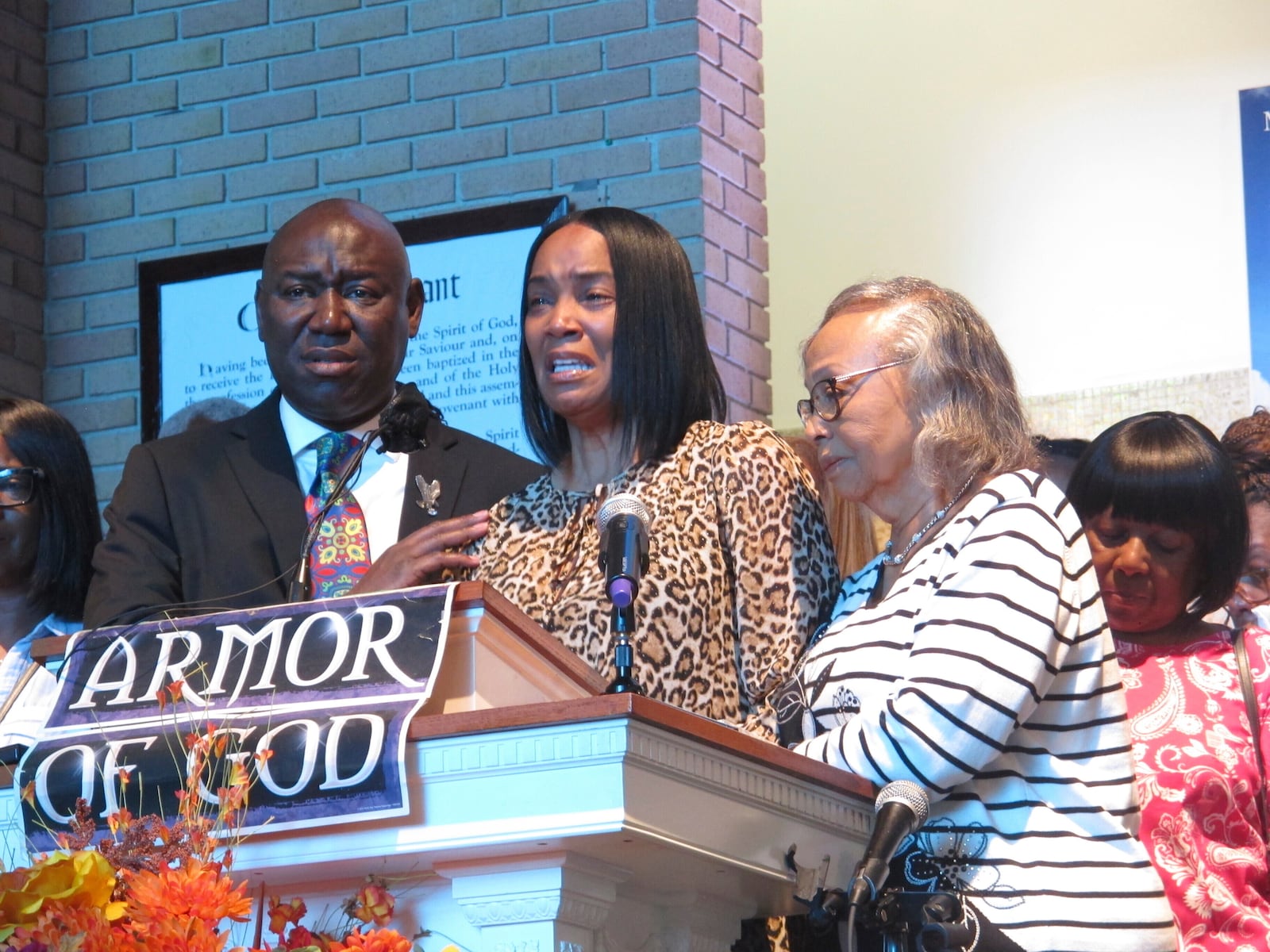 Regina Brinson, center, weeps at a news conference Tuesday, Oct. 22, 2024, while speaking alongside her mother, Katrena Alexander and attorney Ben Crump during a news conference in Jacksonville, Fla. Crump represents families of three of the seven people killed when a ferry dock walkway collapsed on Sapelo Island, Ga., on Saturday, Oct. 19. (AP Photo/Russ Bynum)