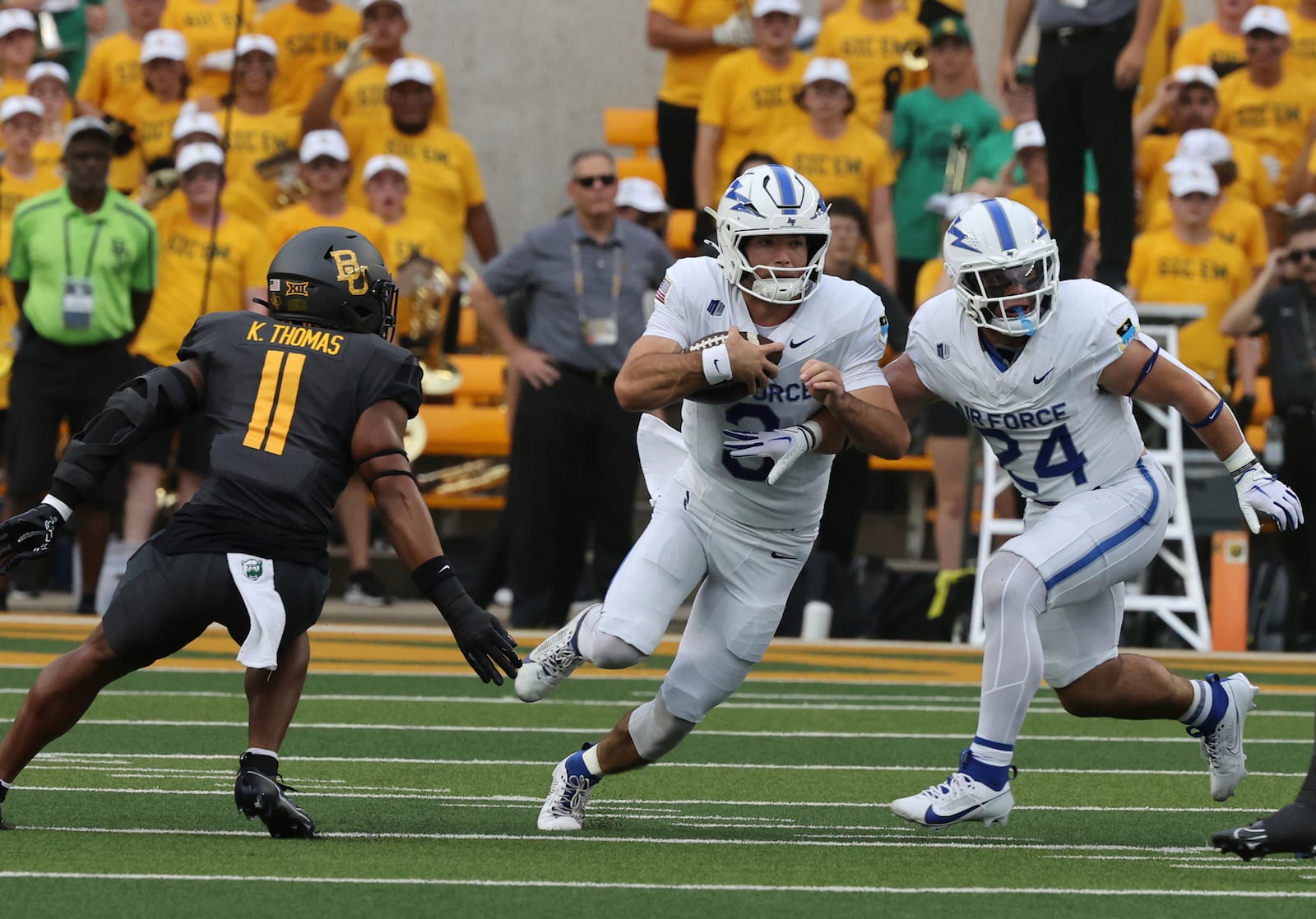 Air Force quarterback Josh Busha, center, gets help from teammate Aiden Calvert, right, while being pressured by Baylor linebacker Keaton Thomas during the first half of an NCAA college football game, Saturday, Sept. 14, 2024, in Waco, Texas. (Rod Aydelotte/Waco Tribune-Herald via AP)