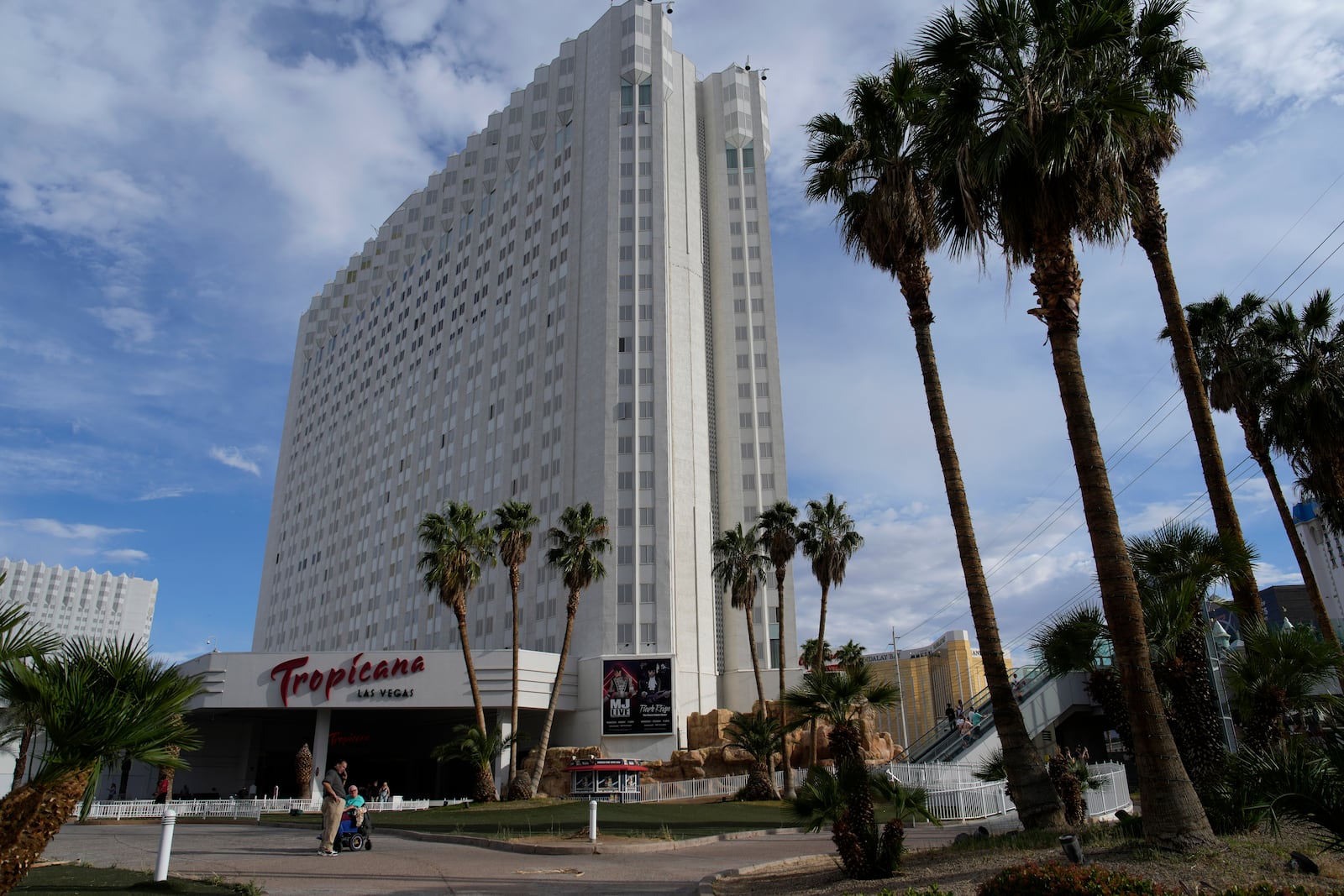 FILE - People stand outside of the Tropicana Las Vegas, Tuesday, May 16, 2023, in Las Vegas. (AP Photo/John Locher, File)