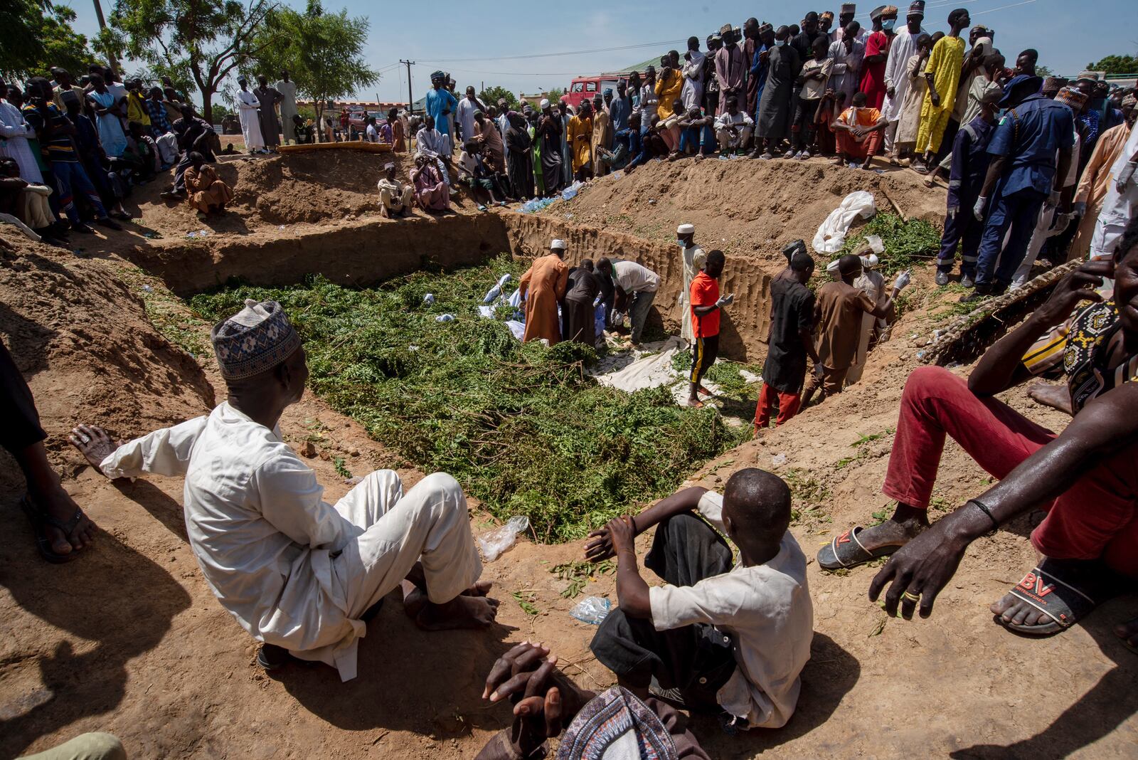 People prepare bodies for burial following a tanker explosion in Majiya town, Nigeria, Wednesday, Oct. 16, 2024. (AP Photo/Sani Maikatanga)