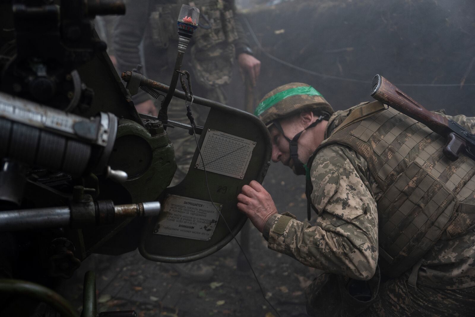 Ukrainian serviceman of Khartia brigade checks the D-30 Howitzer after firing towards Russian positions in Kharkiv region, Ukraine, Wednesday, Oct. 16, 2024. (AP Photo/Alex Babenko)