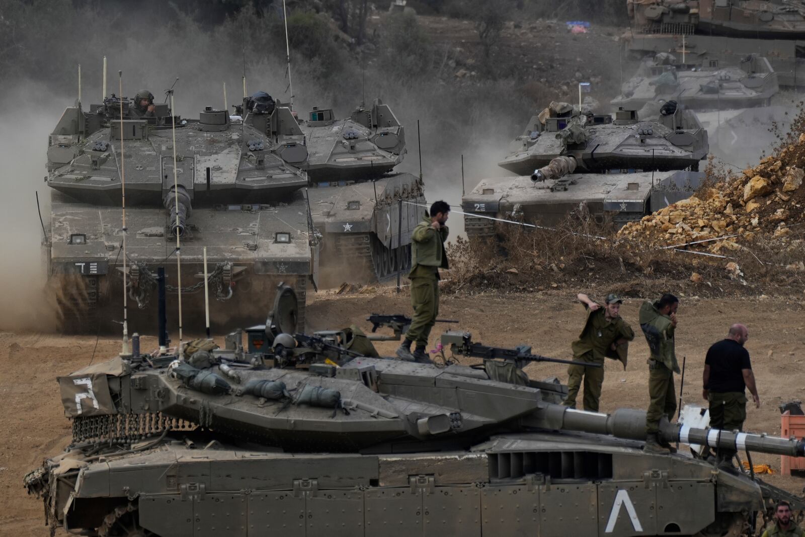 Israeli army tanks manoeuvre in a staging area in northern Israel near the Israel-Lebanon border, Tuesday, Oct. 1, 2024. (AP Photo/Baz Ratner)