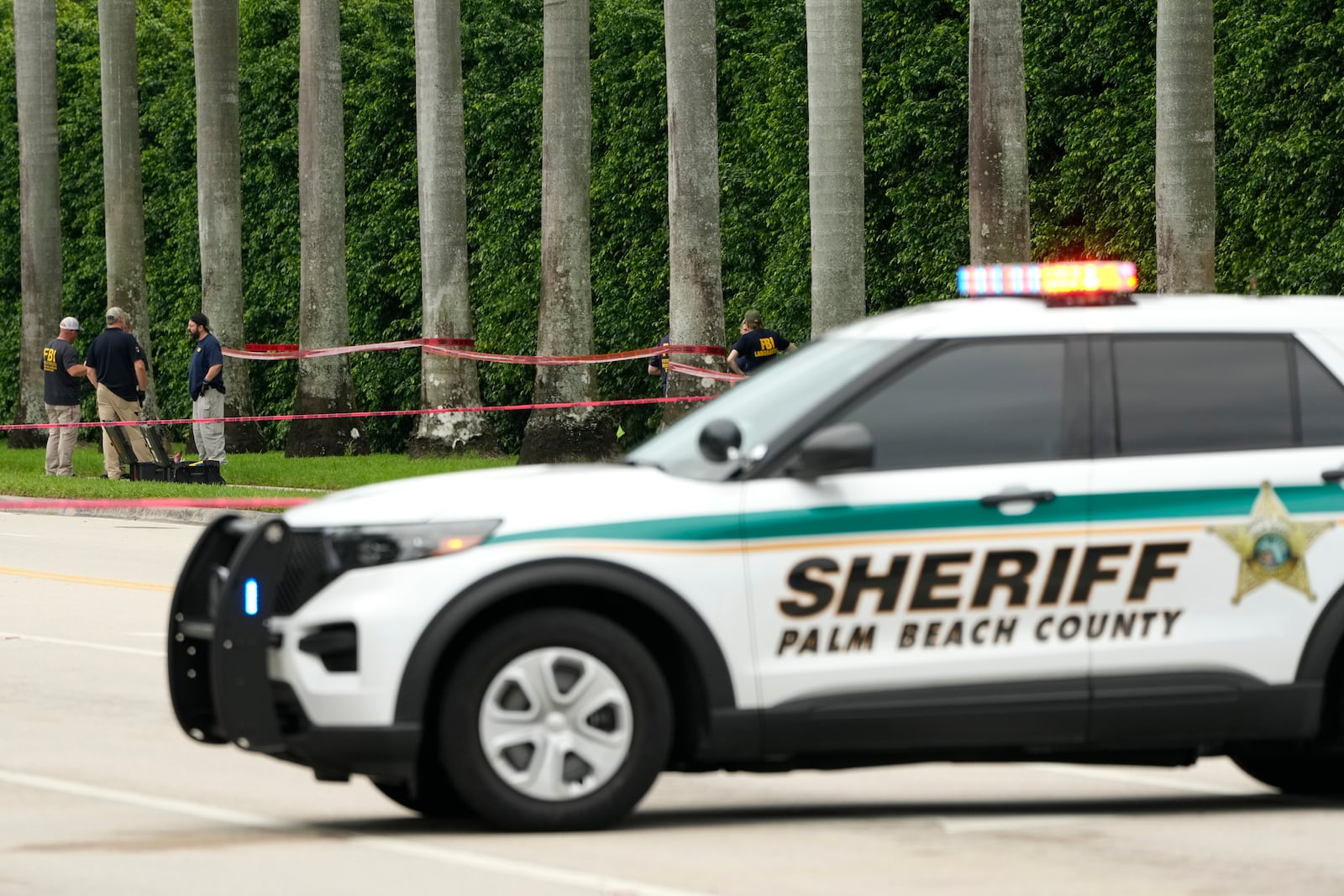 Law enforcement officials work at the scene at the Trump International Golf Club in the aftermath of the apparent assassination attempt of Republican presidential nominee and former President Donald Trump Tuesday, Sept. 17, 2024, in West Palm Beach, Fla. (AP Photo/Lynne Sladky)