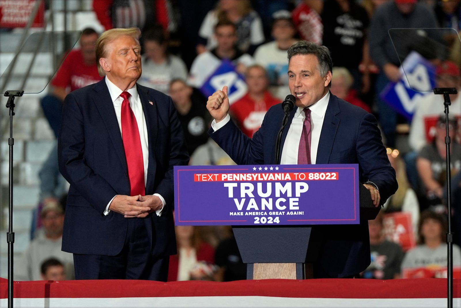 Republican presidential nominee former President Donald Trump listens as Pennsylvania Senate candidate Dave McCormick speaks at a campaign rally at Riverfront Sports, Wednesday, Oct. 9, 2024, in Scranton, Pa. (AP Photo/Julia Demaree Nikhinson)