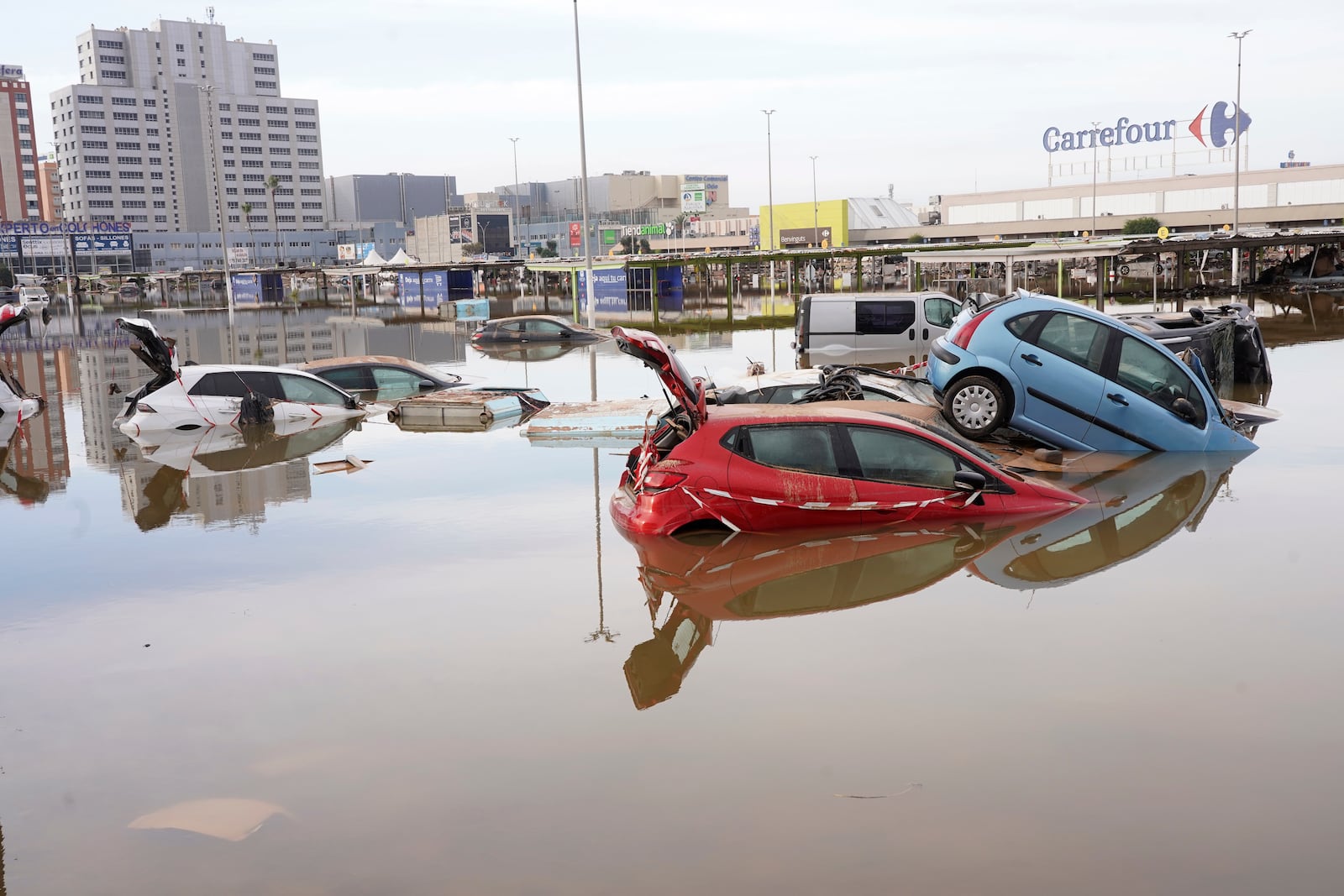 Cars are seen half submerged after floods in Valencia, Spain, Friday, Nov. 1, 2024. (AP Photo/Alberto Saiz)