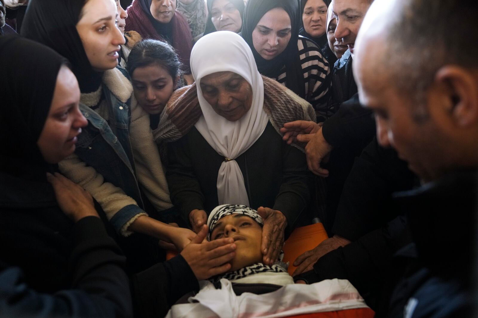 Palestinians mourn over the body of Naji al-Baba,16, who the Palestinian Health Ministry said was killed by Israeli forces in the town of Halhul, West Bank, during his funeral on Monday, Nov. 4, 2024. (AP Photo/Mahmoud Illean)