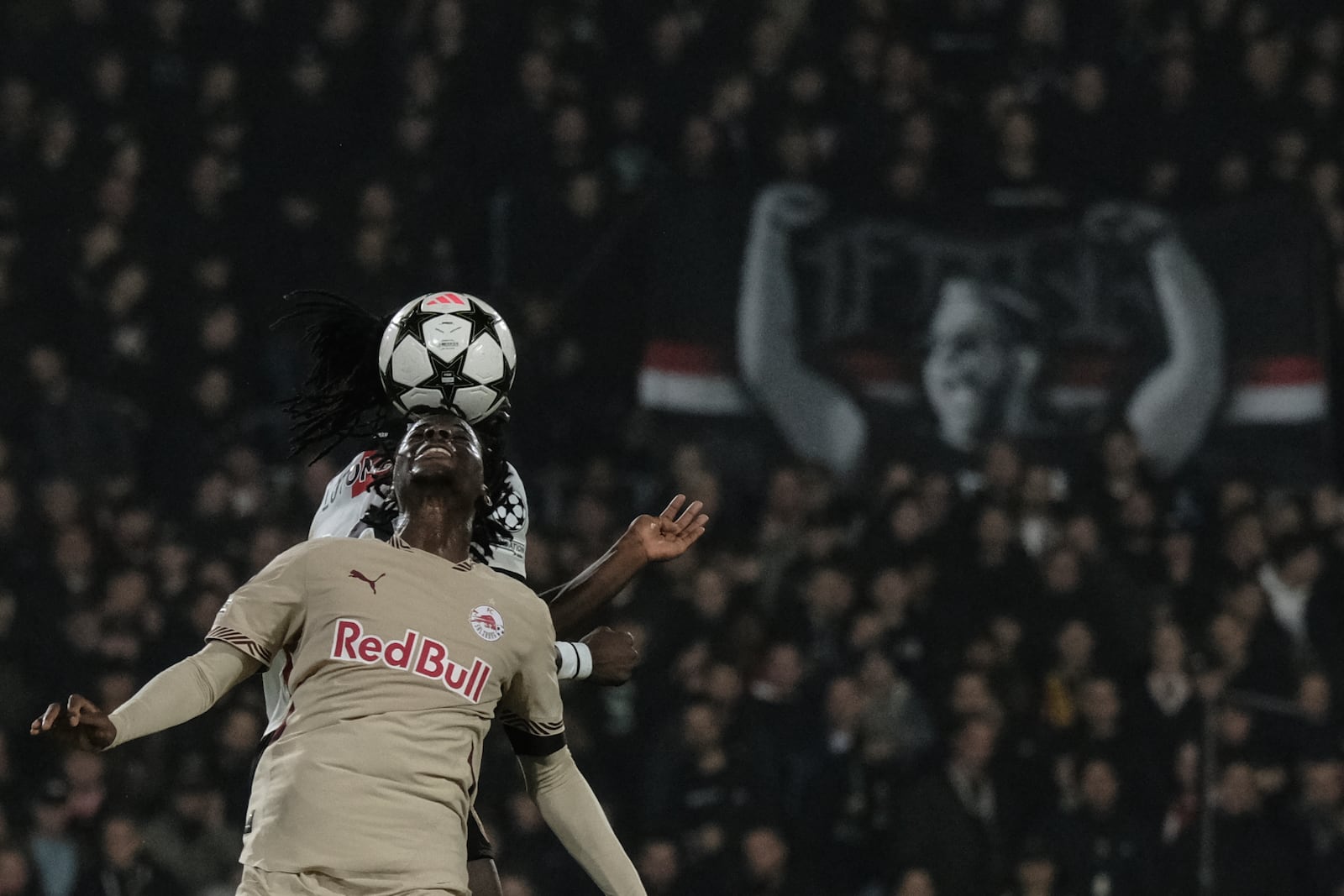 Salzburg's Mamady Diambou, front, challenges for a header with Feyenoord's Jordan Lotomba during the Champions League opening phase soccer match between Feyenoord and Salzburg, in Rotterdam, Netherlands, Wednesday, Nov. 6, 2024. (AP Photo/Patrick Post)