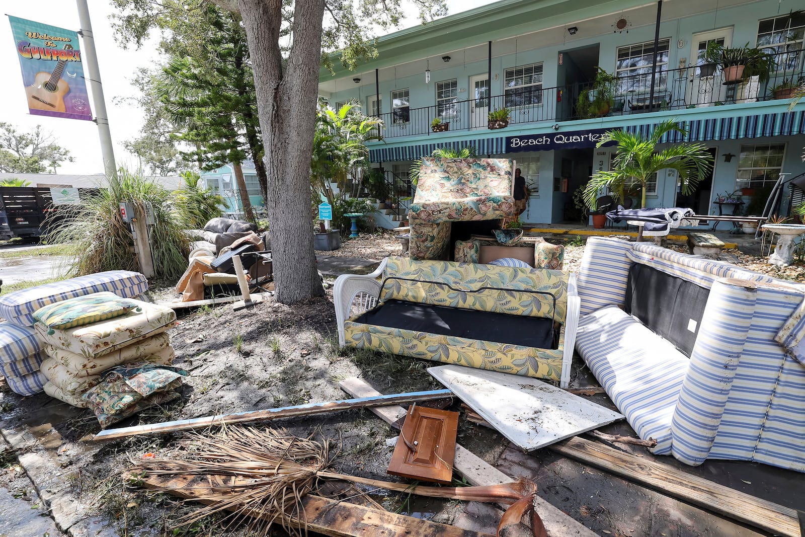 Contents of rooms are emptied on the street after flooding from Hurricane Helene on Friday, Sept. 27, 2024, in Gulfport, Fla. (AP Photo/Mike Carlson)