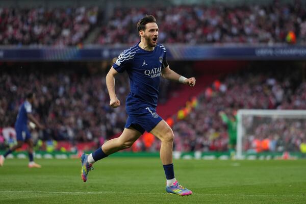 PSG's Khvicha Kvaratskhelia celebrates after his teammate Ousmane Dembele scoring his side's opening goal during the Champions League semifinal first leg soccer match between Arsenal and Paris Saint-Germain at Emirates Stadium in London, England, Tuesday, April 29, 2025. (AP Photo/Kirsty Wigglesworth)