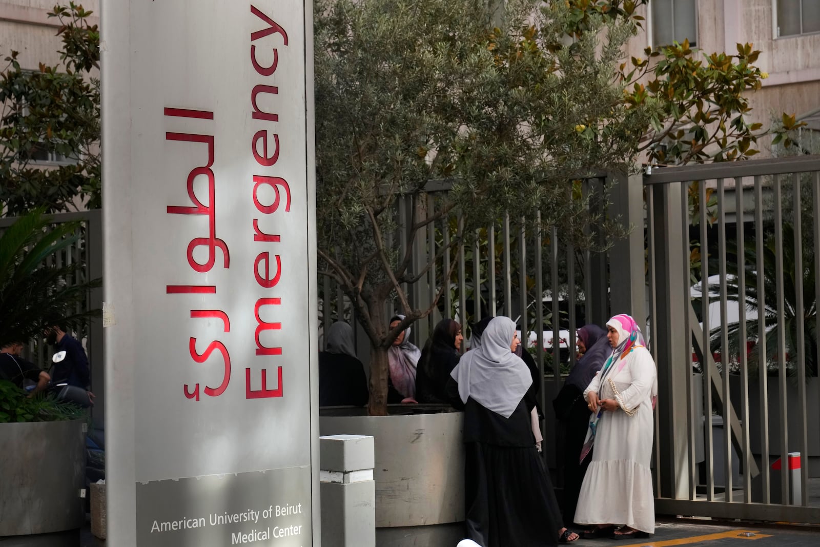 Families of victims who were injured on Monday by their exploding handheld pagers, wait at the emergency entrance of the American University hospital, in Beirut, Lebanon, Wednesday, Sept. 18, 2024. (AP Photo/Hussein Malla)