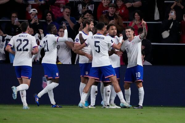 United States' Christian Pulisic, right, is congratulated by teammates after scoring during the first half in a CONCACAF Nations League quarterfinal second leg soccer match against Jamaica Monday, Nov. 18, 2024, in St. Louis. (AP Photo/Jeff Roberson)