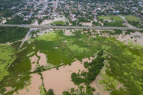 A general view of the Suyapa neighborhood, partially flooded by the Ulúa River's overflow after Tropical Storm Sara, in Potrerillos, Honduras, Sunday, Nov. 17, 2024. (AP Photo/Moises Castillo)