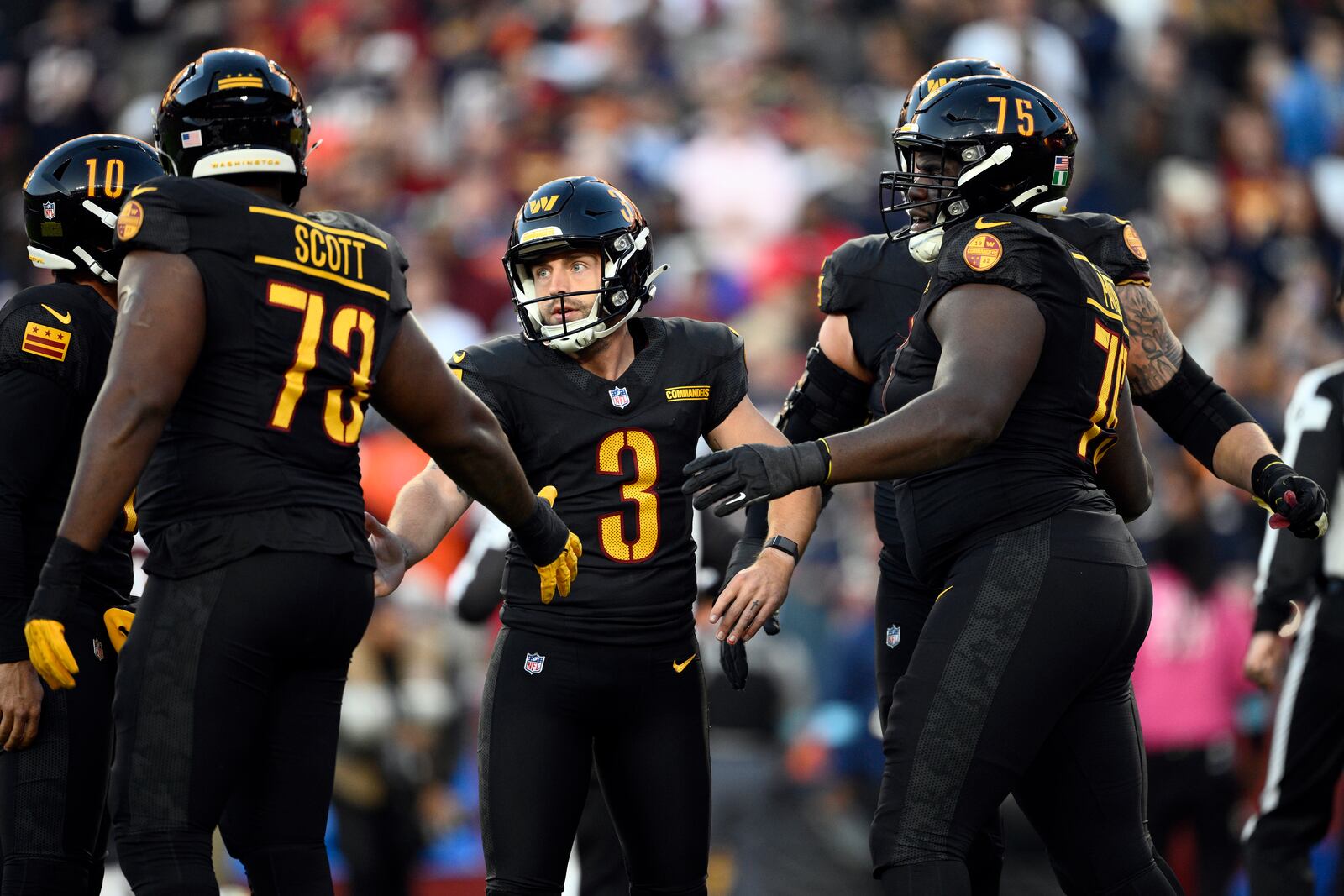 Washington Commanders place kicker Austin Seibert (3) is congratulated after kicking a 28-yard field goal against the Chicago Bears in the first half of an NFL football game Sunday, Oct. 27, 2024, in Landover, Md. (AP Photo/Nick Wass)