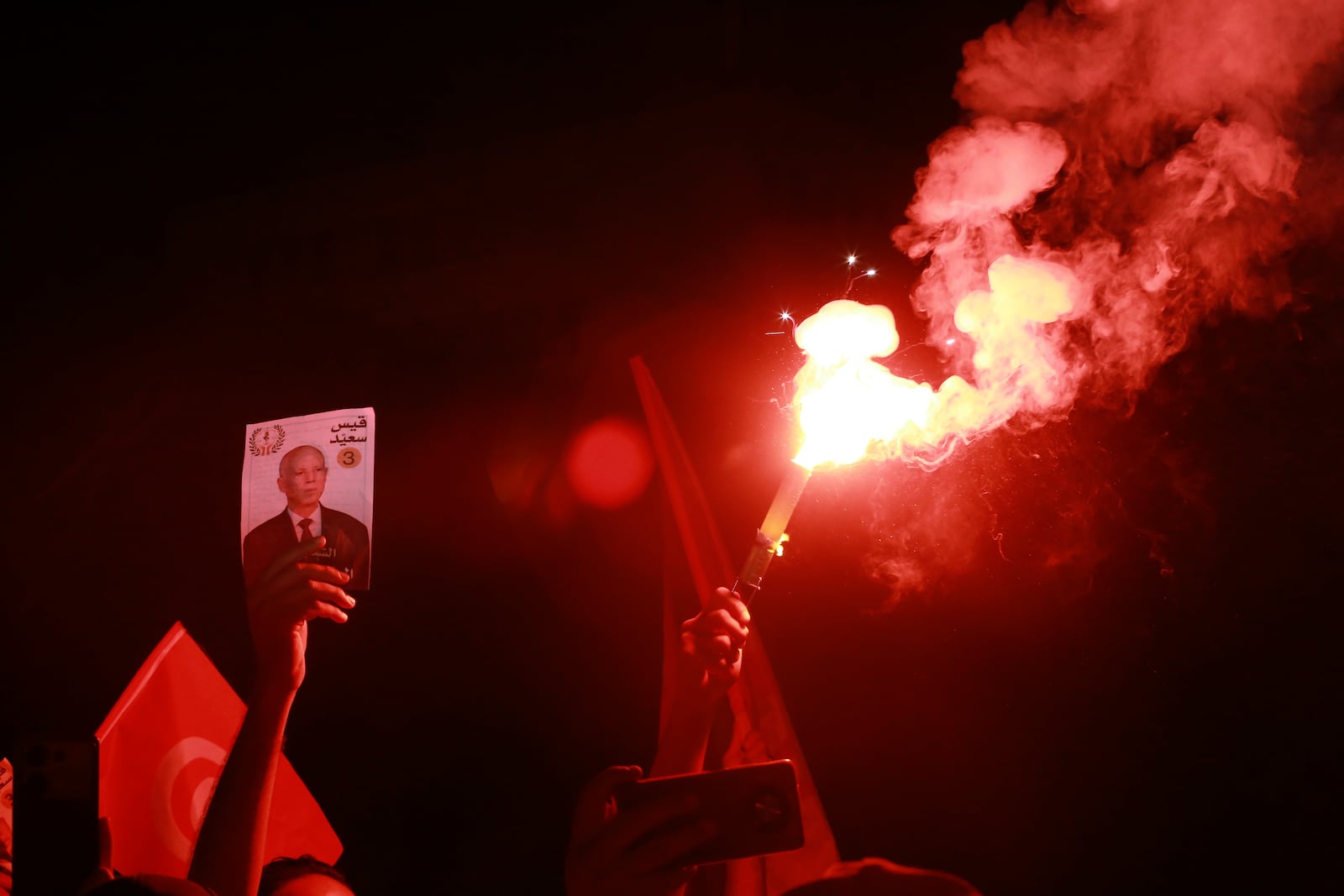 Supporters of Tunisian president and candidate for re-election Kais Saied celebrate after the announcement of the provisional results for the presidential elections, in the capital Tunis, Tunisia, Sunday, Oct. 6, 2024. (AP Photo/Anis Mili)