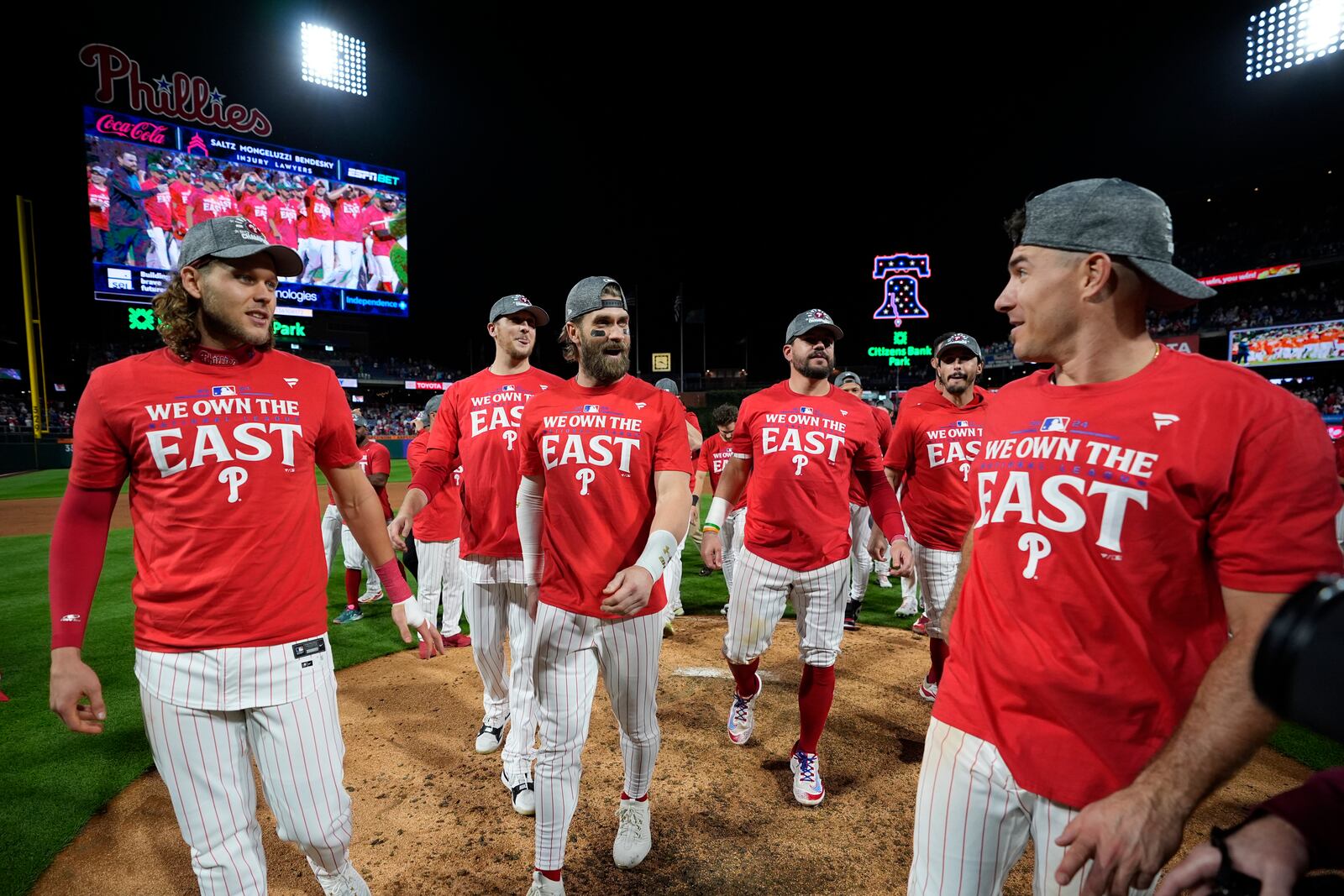 Philadelphia Phillies' Alec Bohm, from left, Jeff Hoffman, Bryce Harper, Kyle Schwarber, Garrett Stubbs and J.T. Realmuto celebrate after winning a baseball game against the Chicago Cubs to clinch the NL East title, Monday, Sept. 23, 2024, in Philadelphia. (AP Photo/Matt Slocum)