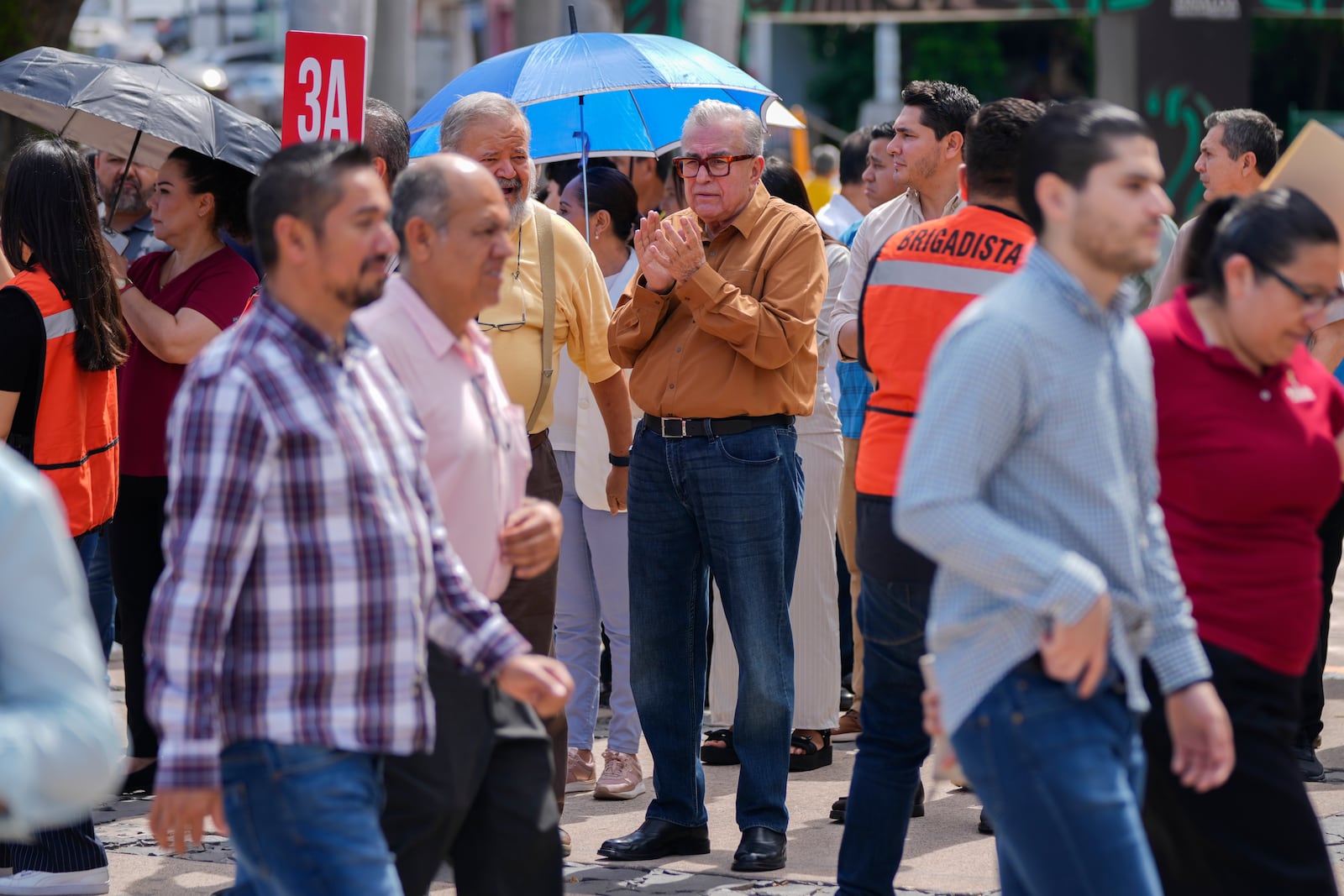 Sinaloa state Gov. Ruben Rocha, center, participates in an annual earthquake drill in Culiacan, Mexico, Thursday, Sept. 19, 2024. (AP Photo/Eduardo Verdugo)