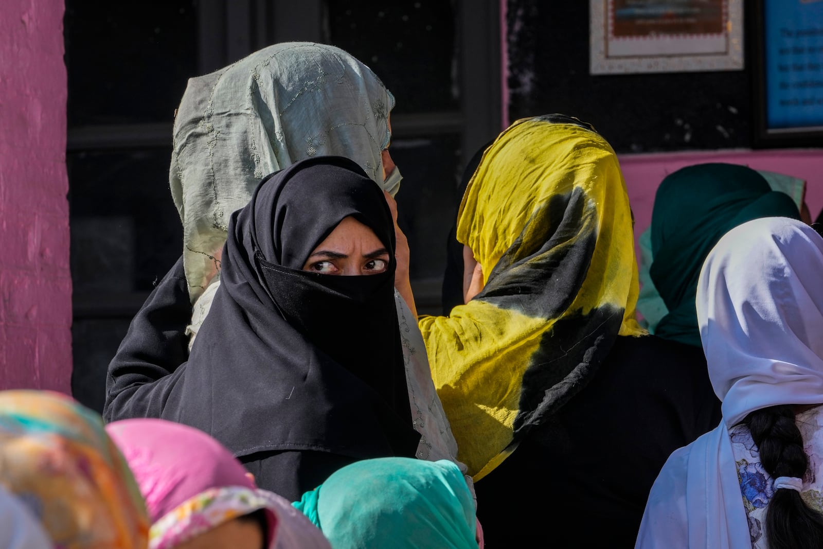 Kashmiris queue up at a polling booth to cast their vote during the final phase of an election to choose a local government in Indian-controlled Kashmir, north of Srinagar, Tuesday, Oct.1, 2024. (AP Photo/Mukhtar Khan)