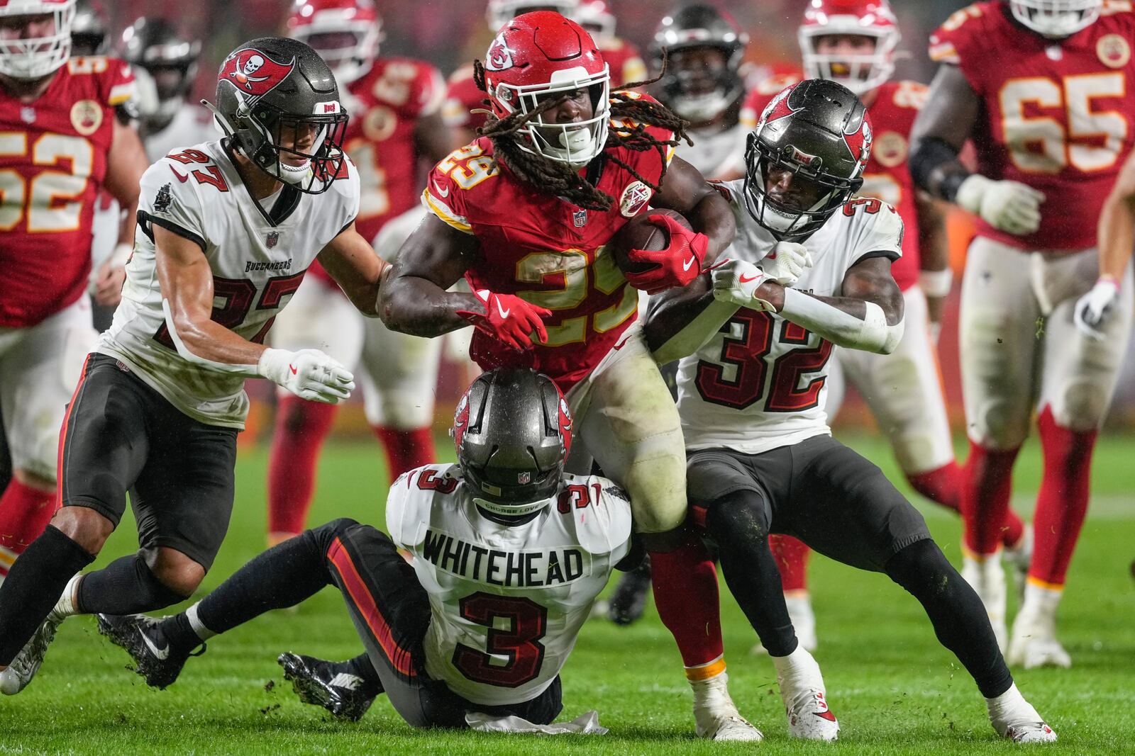 Kansas City Chiefs running back Kareem Hunt (29) runs into Tampa Bay Buccaneers safety Jordan Whitehead (3) during the second half of an NFL football game, Monday, Nov. 4, 2024, in Kansas City, Mo. (AP Photo/Ed Zurga)