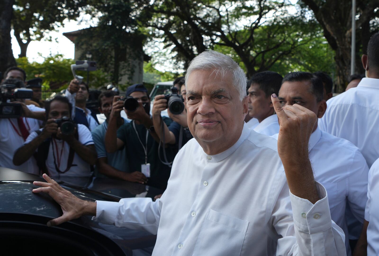 Sri Lankan president and independent presidential candidate Ranil Wickremesinghe shows indelible mark on his baby finger after casting his vote, in Colombo, Sri Lanka, Saturday, Sept. 21, 2024. (AP Photo/Rajesh Kumar Singh)