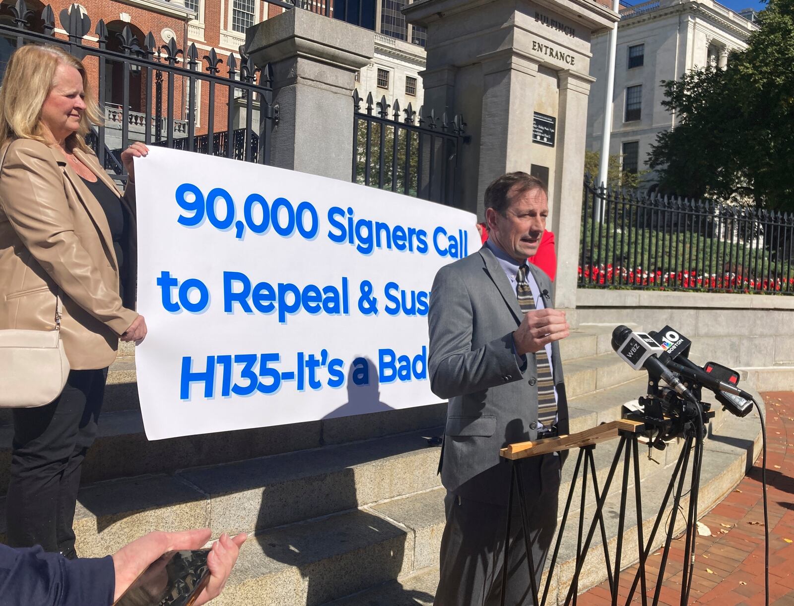 Gun shop owner and 2nd Amendment advocate Toby Leary announces outside the Massachusetts Statehouse in Boston, Tuesday, Oct. 8, 2024, that firearms activists have collected enough signatures to place a question on the Massachusetts 2026 ballot that would repeal the state's new sweeping gun law. (AP Photo/Steve LeBlanc)