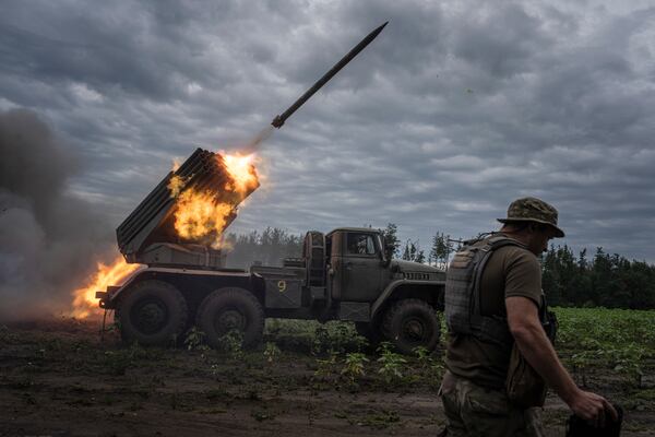 FILE - Ukrainian forces shoot toward Russian positions at the front line in Kharkiv region, Ukraine, on Tuesday, Aug. 2, 2022. (AP Photo/Evgeniy Maloletka, File)