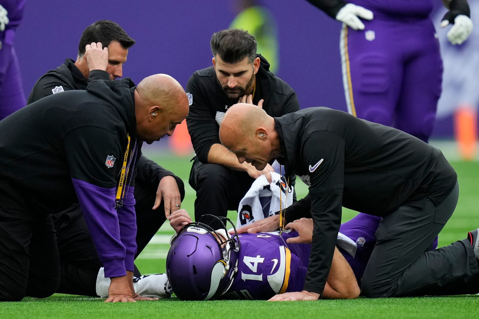 Medical staff attend to Minnesota Vikings quarterback Sam Darnold during the first half of an NFL football game against the New York Jets, Sunday, Oct. 6, 2024, at the Tottenham Hotspur stadium in London. (AP Photo/Kirsty Wigglesworth)