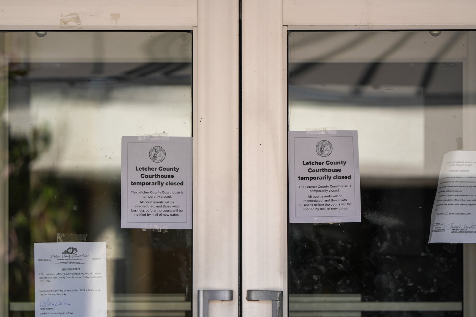 Signs indicating that the Letcher County Courthouse is closed on Friday, Sept. 20, 2024, in Whitesburg, Ky. A preliminary investigation indicates Letcher County Sheriff Shawn “Mickey” Stines shot District Judge Kevin Mullins multiple times following an argument inside the courthouse, according to Kentucky State Police. (AP Photo/Randy Sartin)