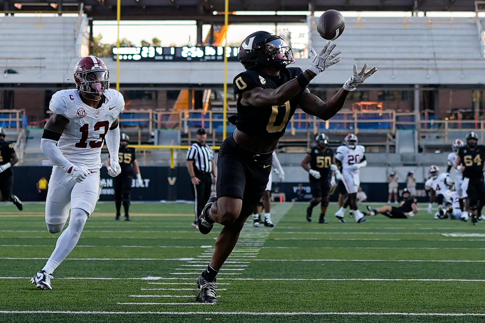 Vanderbilt wide receiver Junior Sherrill (0) makes a catch for a touchdown past Alabama defensive back Malachi Moore (13) during the second half of an NCAA college football game Saturday, Oct. 5, 2024, in Nashville, Tenn. (AP Photo/George Walker IV)