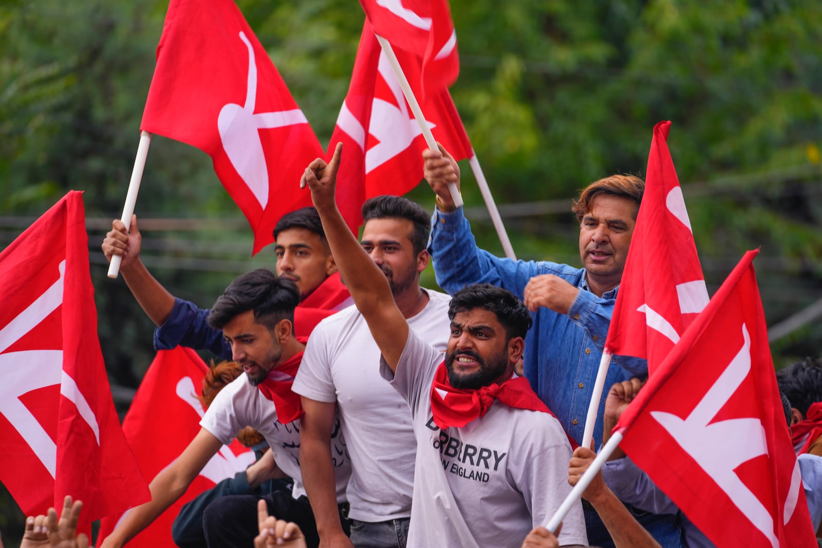 Supporters of National Conference party shout slogans as they celebrate early leads in the election for a local government in Indian controlled Kashmir, Srinagar, Tuesday, Oct. 8, 2024. (AP Photo/Dar Yasin)