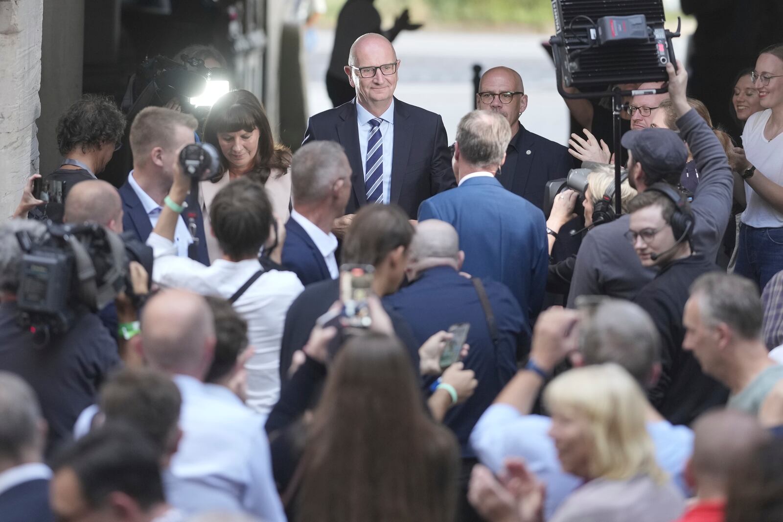 Governor of Brandenburg and Germany's Social Democratic Party, SPD, top candidate for the state election, Dietmar Woidke, center, arrives at the party's election event after first exit polls announced in Potsdam, Germany, Sunday, Sept. 22, 2024. (AP Photo/Markus Schreiber)