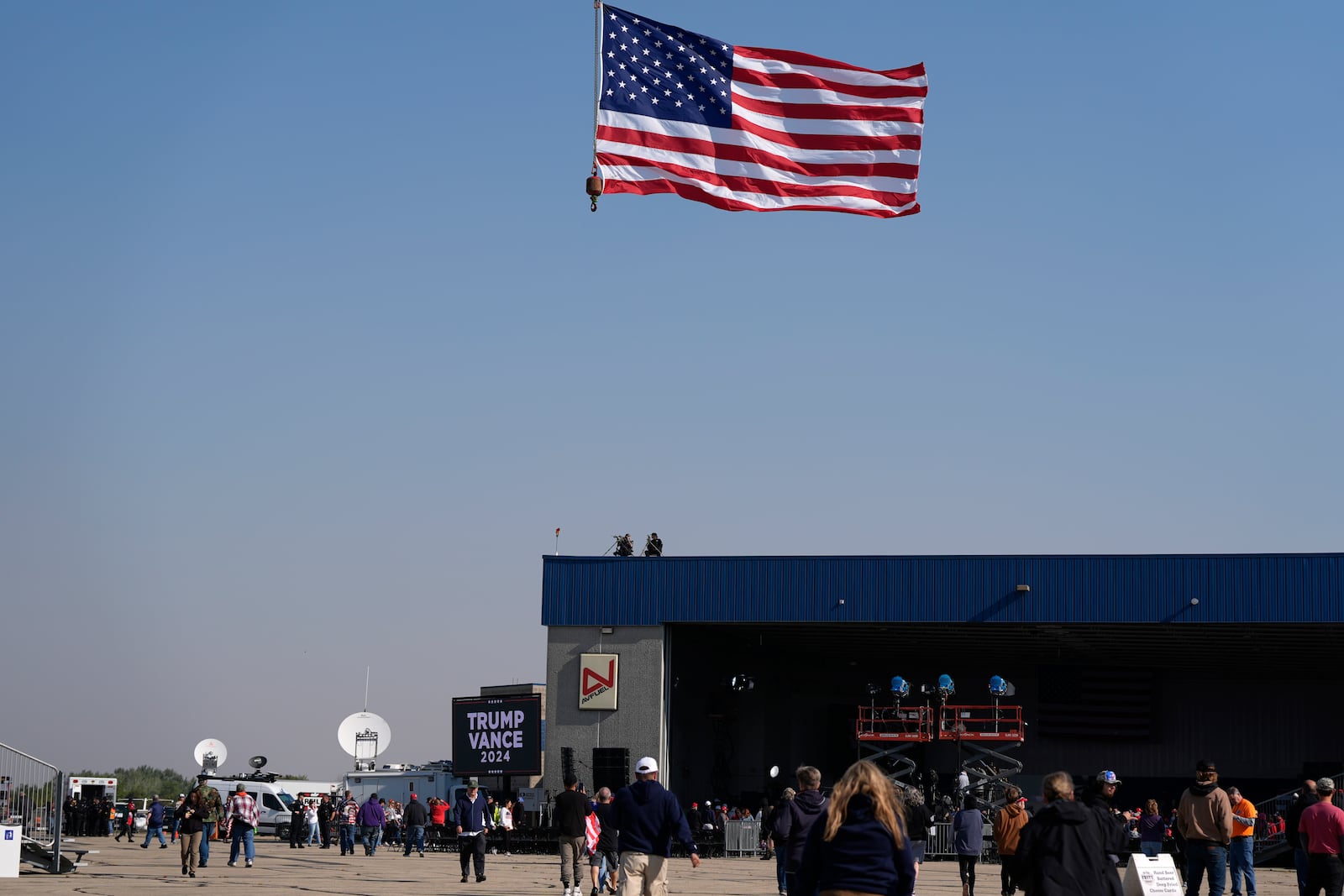 Attendees arrive at a campaign rally for Republican presidential nominee former President Donald Trump at Dodge County Airport, Sunday, Oct. 6, 2024, in Juneau, Wis. (AP Photo/Julia Demaree Nikhinson)