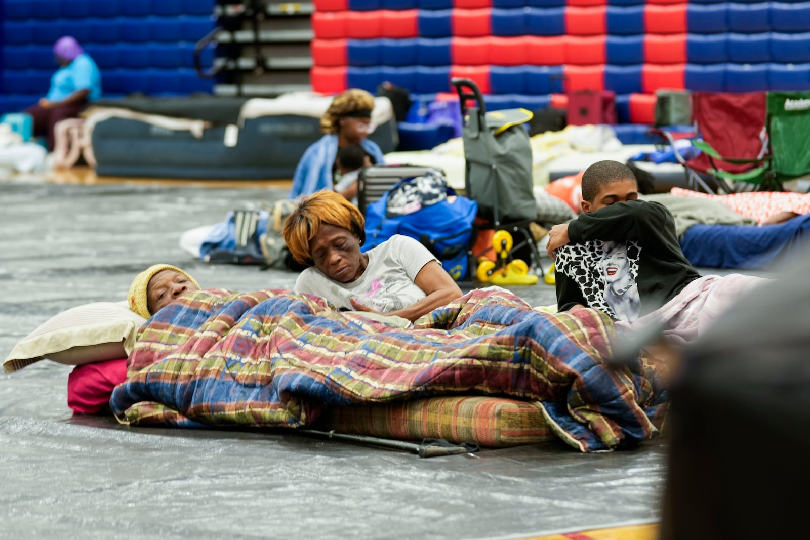 Bobby Joe Edwards, Sr., and his wife Lillie Edwards, of Walkalla, Fla., and their grandson Tavarrious Dixon, rest inside a hurricane evacuation shelter at Fairview Middle School, ahead of Hurricane Helene, expected to make landfall here today, in Leon County, Fla., Thursday, Sept. 26, 2024. (AP Photo/Gerald Herbert)