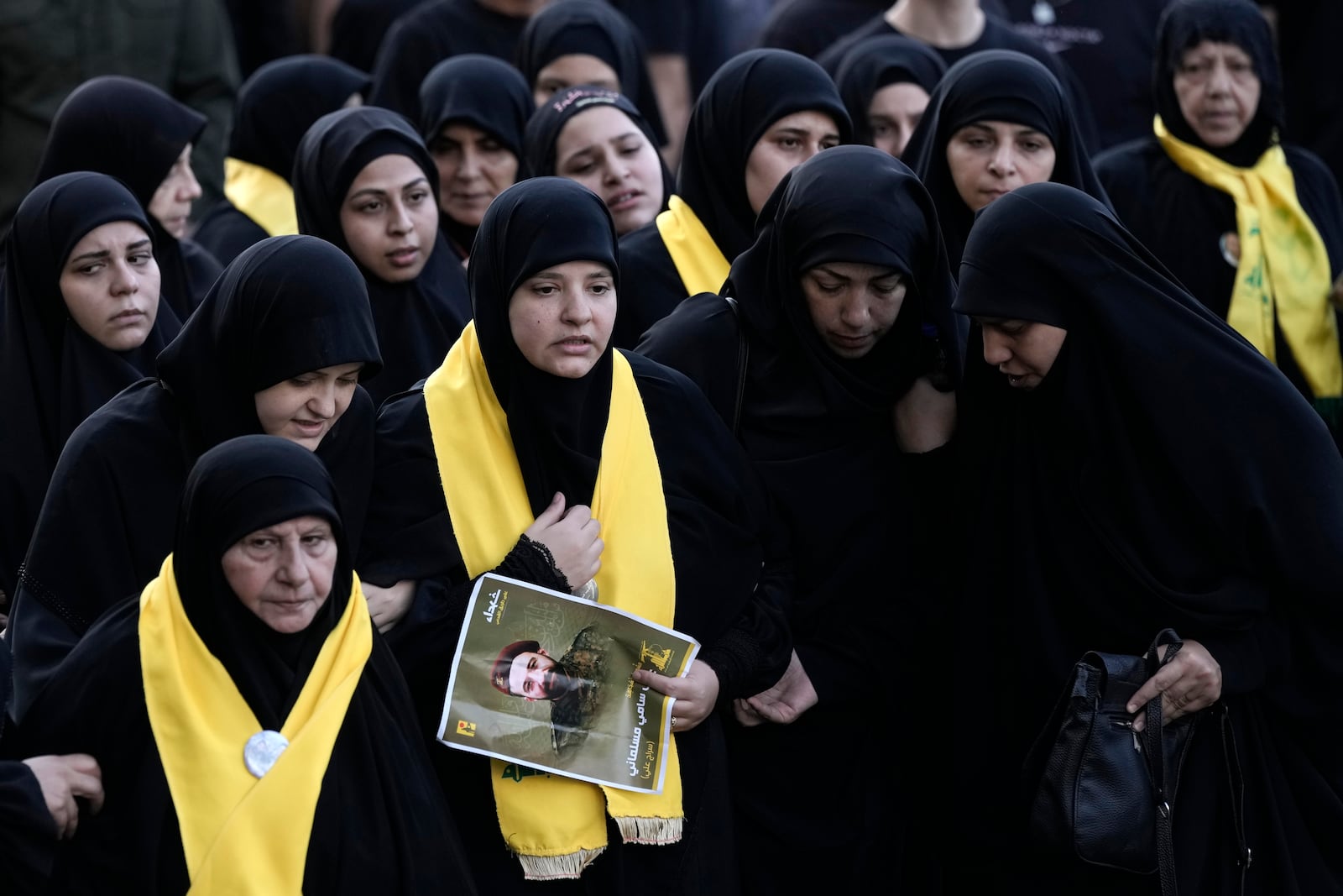 Women attend the funeral of Hezbollah fighters who were killed in Friday's Israeli strike in the southern suburb of Beirut, Lebanon, Saturday, Sept. 21, 2024. (AP Photo/Bilal Hussein)