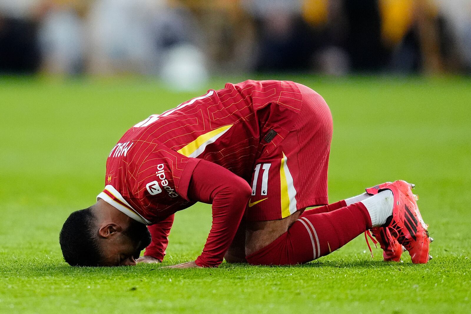 Liverpool's Mohamed Salah celebrates scoring his side's second goal of the game during the English Premier League soccer match between Wolverhampton Wanderers and Liverpool at the Molineux Stadium in Wolverhampton, England, Saturday, Sept. 28, 2024. (Nick Potts/PA via AP)