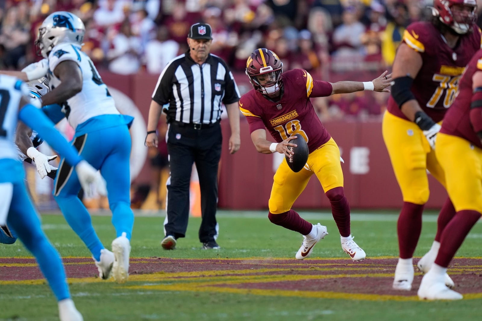 Washington Commanders quarterback Marcus Mariota (18) runs up field during the first half of an NFL football game against the Carolina Panthers, Sunday, Oct. 20, 2024, in Landover, Md. (AP Photo/Stephanie Scarbrough)