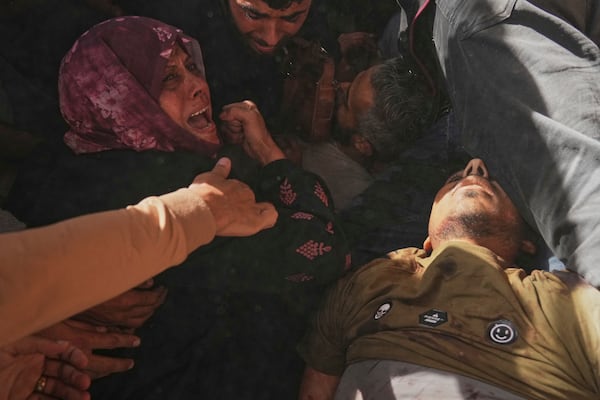 A woman reacts over the bodies of some of the victims of an Israeli army strike on a restaurant, which killed at least 29 people, as they are carried from the scene to a hospital in Gaza City, Wednesday, May 7, 2025.(AP Photo/Jehad Alshrafi)