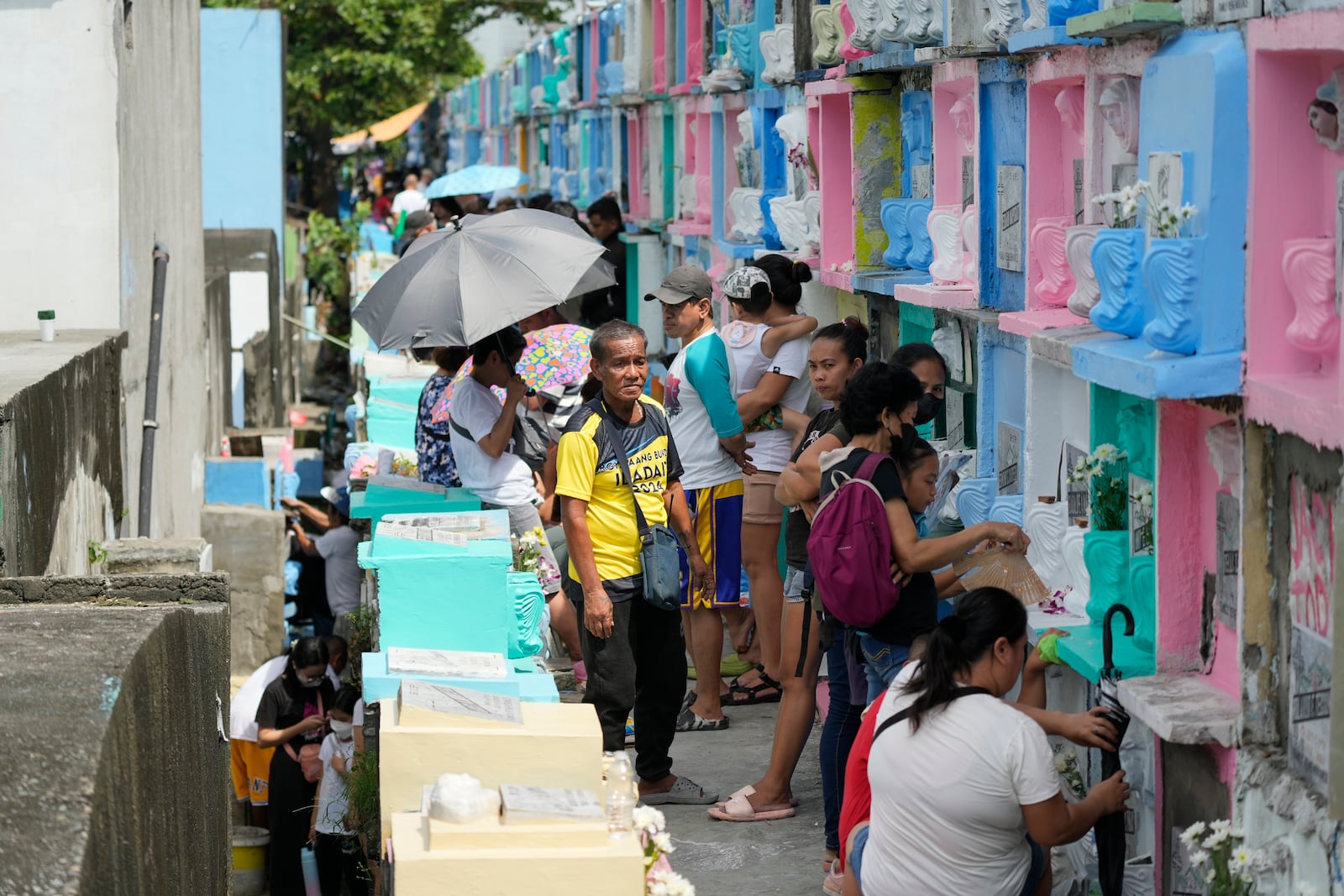 People visit apartment-type tombs of their departed loved ones at Manila's North Cemetery, Philippines as the nation observes All Saints Day on Friday, Nov. 1, 2024. (AP Photo/Aaron Favila)