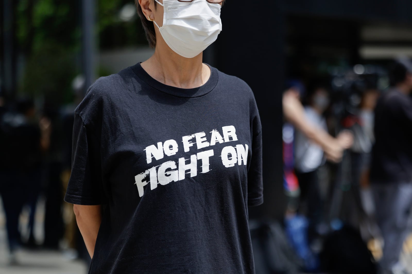 A member of the public stands outside the District Court in Wan Chai, Hong Kong, ahead of a sentencing hearing for two former Stand News editors convicted of sedition, Thursday, Sept. 26, 2024. (AP Photo/May James)