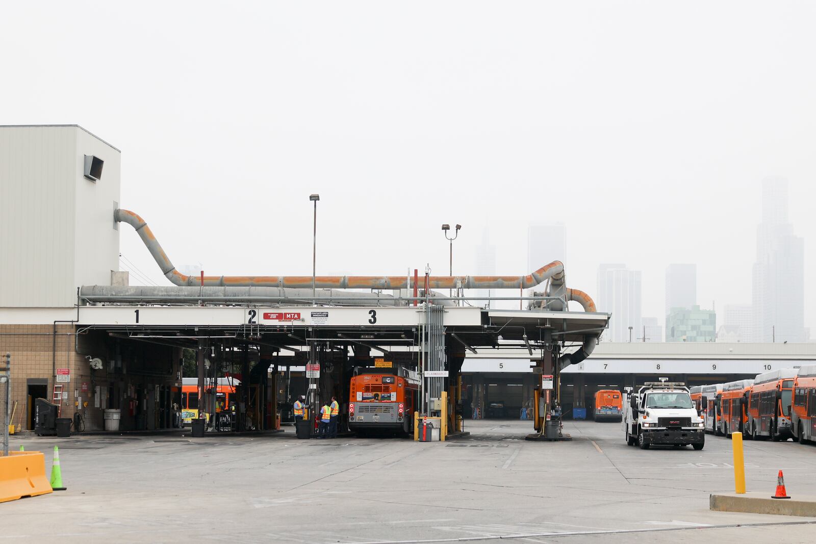 Buses enter a Los Angeles MTA bus depot near the site where overnight a bus was hijacked by an armed subject with passengers on board Wednesday, Sept. 25, 2024, in Los Angeles. One person was fatally shot before police apprehended the suspect. (AP Photo/Ryan Sun)