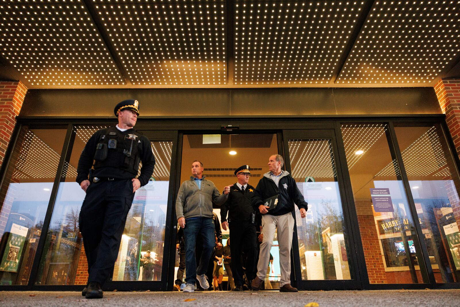 Police officials walk out to give a brief of a shooting at Navy Pier during a news conference outside the main entrance, Tuesday, Nov. 5, 2024 in Chicago. (Anthony Vazquez/Chicago Sun-Times via AP)