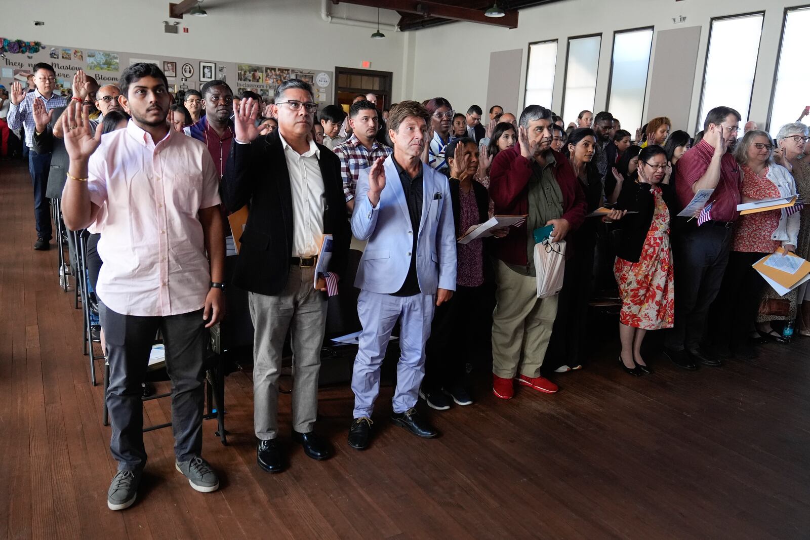 One hundred people take the oath to become American citizens during a naturalization ceremony at the high school attended by former President Jimmy Carter on Carter's 100th birthday Tuesday, Oct. 1, 2024, in Plains, Ga. (AP Photo/John Bazemore)