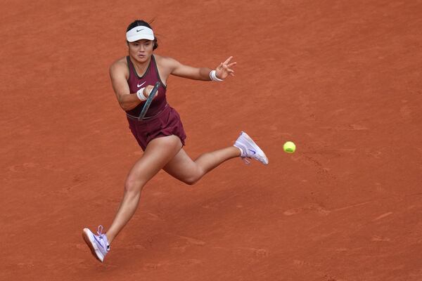 Britain's Emma Raducanu returns the ball to Poland's Iga Swiatek during their second round match of the French Tennis Open, at the Roland-Garros stadium, in Paris, Wednesday, May 28, 2025. (AP Photo/Christophe Ena)